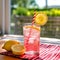 Refreshing Pink Lemonade with Striped Straw on Picnic Table