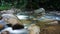 Refreshing river stream in lush green forest in Kuala Kubu Bharu, Selangor, Malaysia.