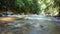 Refreshing river stream in lush green forest in Kuala Kubu Bharu, Selangor, Malaysia.