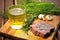 refreshing saison beer on a coaster next to a barbecued, herb-marinated steak