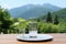 Refreshing Scene of Clear Water in Glass with Lush Forests and Majestic Mountains as a Backdrop