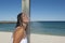 Refreshing shower for woman at the ocean