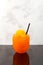 Refreshing Slush drink. Summer ice drink. Glass of Orange Granizado. Sweet citrus Shaved ice