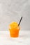 Refreshing Slushie drink in disposable plastic cup. Orange Granizado. Summer ice drink. Sweet citrus Shaved ice. Take away food