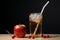 Refreshing snack Apple, cardboard box, and straw filled glass offer delightful choices