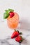 Refreshing strawberry and basil cocktails on white marble surface