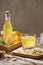 Refreshing summer drink with lemon, ginger, rosemary and ice on rustic wooden table, copy space