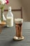 Refreshing summer drinks or beverages, chocolate cocoa latte with chocolate sauce and cold foam milk on top in a tall glass, on