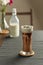 Refreshing summer drinks or beverages, chocolate cocoa latte with chocolate sauce, and cold foam milk on top in a tall glass