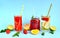 Refreshing summer drinks of lemon, lime, strawberry, orange, mint on a blue background. Detox, healthy eating, fitness drinks.