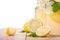 Refreshing and tasty summer drinks with ripe, juicy and fresh lemons, bright green mint and miner, isolated on a white background.