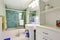 Refreshing white bathroom with aqua tile wall trim