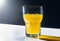 refreshing yellow carbonated drink in a tall glass. Cold glass, drops of condensation, orange juice, lemon juice,