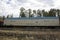 Refrigerated car as part of a freight train on rails.