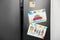 Refrigerator with child`s drawings and magnets