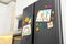 Refrigerator with child`s drawings, notes and magnets in kitchen