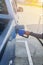 Refueling Car fills with petrol gasoline at a gas station and Petrol pump filling fuel nozzle in the fuel tank of the car