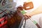 Refueling the car at a gas station fuel pump. Man driver hand refilling and pumping gasoline oil the car with fuel at he refuel