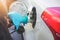 Refueling car in gasoline station. Close up,woman driver hand squeeze the handle.
