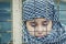 A refugee girl from the east in a headscarf