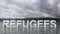 Refugee text emerging from water with mountains and sky