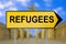 Refugees traffic sign with blurred Berlin background