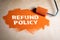 Refund Policy concept. Paint roller with orange paint on a wooden surface