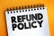 Refund Policy text on notepad, business concept background