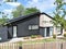 A refurbished 1960`s bungalow clad with external western red cedar and black timber rainscreen cladding