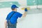 Refurbishment. Plasterer worker spackling a wall with putty