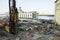 Refurbishment of the Pochtovaya square, concrete hydraulic static pile driver, digger and builders working