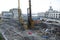 Refurbishment of the Pochtovaya square, concrete hydraulic static pile driver, digger and builders working