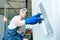 Refurbishment. Worker spackling a wall with putty