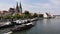 Regensburg, Germany - 26 July, 2018: Wooden medieval-looking salt merchant ship sails on Danube river, tourists on board