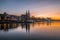 Regensburg during sunset with Danube river and cathedral and stone bridge at golden hour, Germany