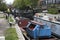 Regent`s Canal as seen from junction of Broadway Market and Andrews Road with barges, runner and gasometer, in London Borough of H