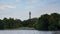 Regent`s Park in London, England with Lake in foreground, and the BT tower behind trees in the background.