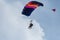 Reggio Emilia, Italy - May 2017: Parachutists: Instructor and Beginner with Blue Parachute against Clear Blue Sky