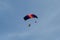 Reggio Emilia, Italy - May 2017: Parachutists: Instructor and Beginner with Blue Parachute against Clear Blue Sky