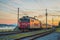 Regio Jet passenger train from Prague to Rijeka on its way over the Ljubljana marshes in early romantic morning with sunrise