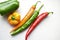 Regular and capsicum yellow and green pepper on a white background