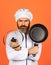 Regular cooking. Preparing food in kitchen. Cooking food concept. High quality frying pan. Bearded man cook white