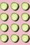 Regular seamless creative pattern of cucumber slices on a pink background.