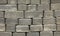 Regular shape blocks, texture, background. Paving slabs of gray blocks of flat shape, close-up. Pavement blocks in city park