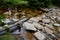 Regulation of poor water flow of the stream when it is necessary to slow down the flow of water in front of the bridge using beams