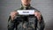 Rehab word written on sign in hands of male soldier, military disorder, health