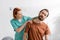rehabilitation specialist examining painful neck of