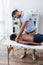 rehabilitologist doing massage to mature african