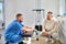 rehabilitologist and male patient discussing treatment