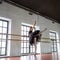 Rehearsal ballerina in the hall. Wooden floor, very large windows. Beautiful ballerina in the rehearsal room